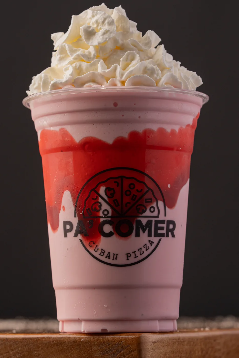 Strawberry ice cream shake with whipped cream in a Pa’ Comer cup