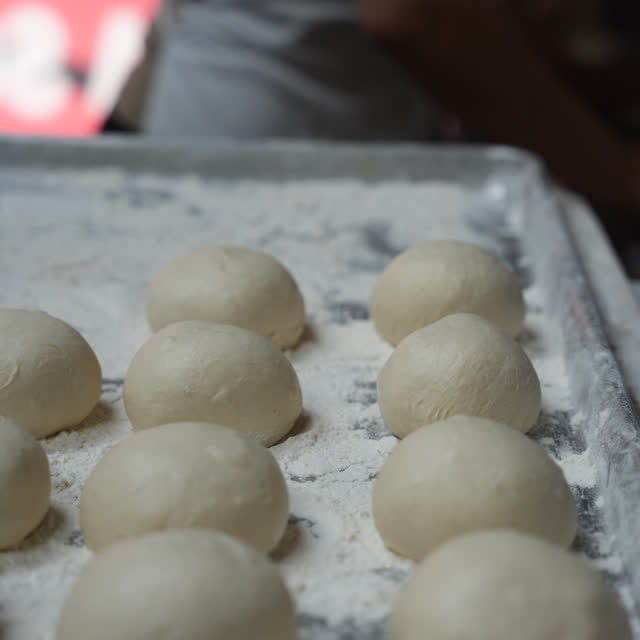 Dough balls made on site, ready for the oven