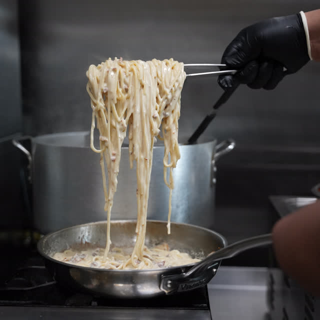 Spaghetti coming out of the pot in the shop kitchen