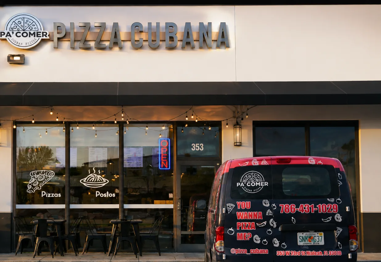 The PA' COMER storefront in Hialeah, with the lit sign and the delivery van parked outside
