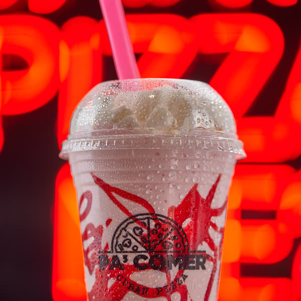 A 16-ounce strawberry ice cream shake, made with ice cream and milk
