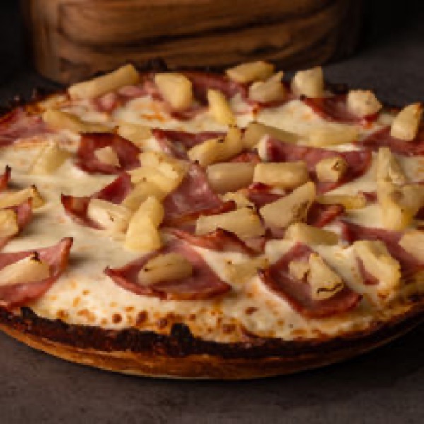 A 9-inch Cuban hawaiian pizza cut into four slices