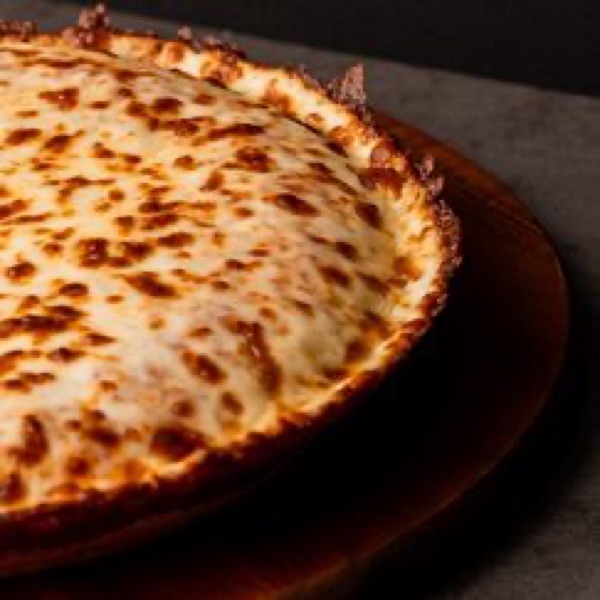 A freshly baked 9-inch Cuban cheese pizza at Pa’ Comer